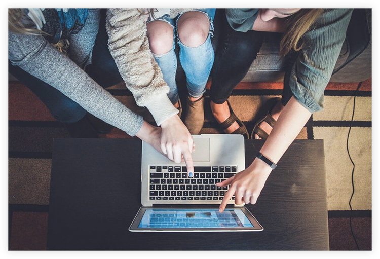3 girls working on a laptop
