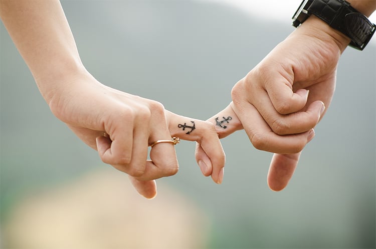 couple holding each other's by fingers