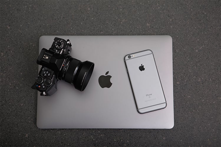 photograph of apple macbook and iphone