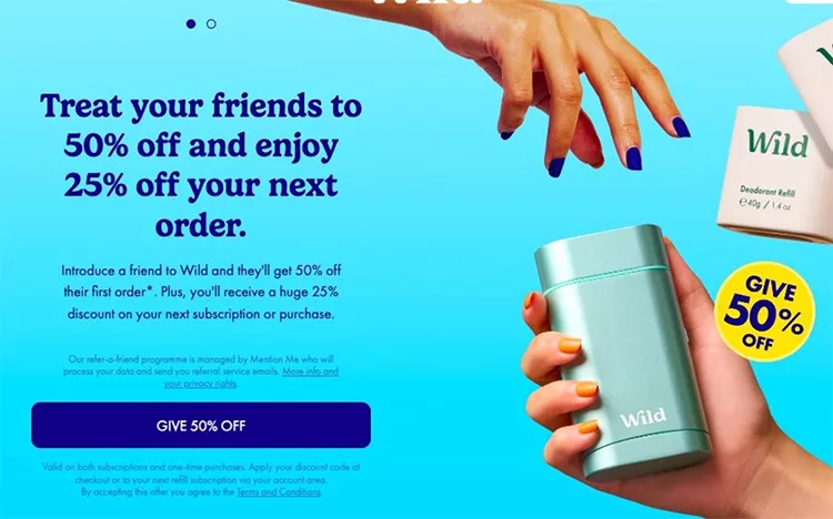 Hands holding Wild deodorant products against a blue background. Text offers 50% off to friends and a 25% discount on the next order. "Give 50% Off" button at the bottom.