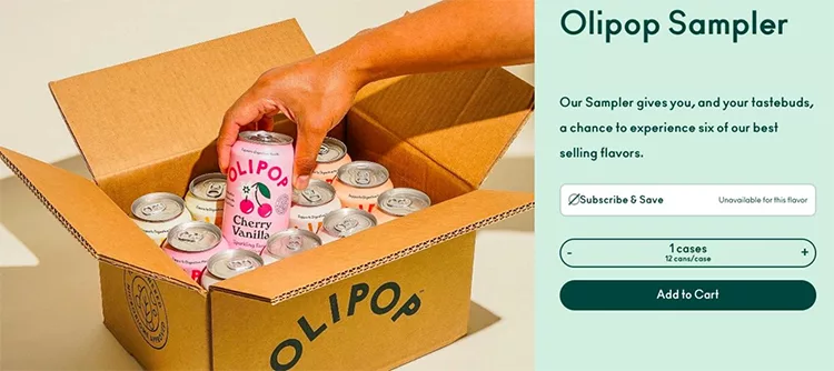 A person is placing a can of Olipop Cherry Vanilla soda into an open box filled with other cans. The image promotes an "Olipop Sampler" with a subscribe and save option and an add to cart button.