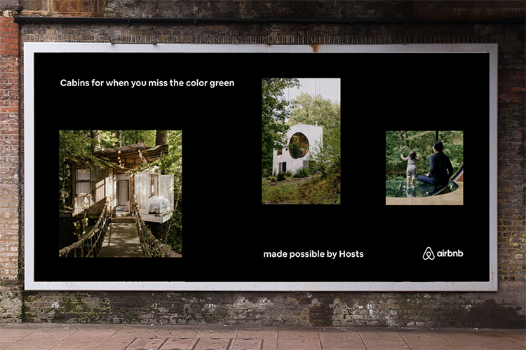 Billboard featuring three images of cabins surrounded by greenery with the text, "Cabins for when you miss the color green" and logos of Airbnb and the phrase "made possible by Hosts.