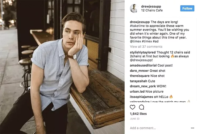 A man in a short-sleeved shirt leans on a wooden counter outside a café, resting his head on his hand and looking into the distance. Numerous comments and engagements are visible on the Instagram post.