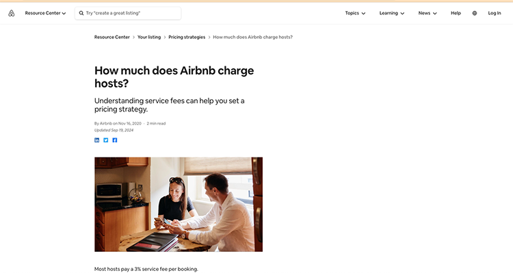 Two people using a tablet at a table in a modern kitchen, discussing Airbnb pricing strategies. The webpage's title is, "How much does Airbnb charge hosts?.